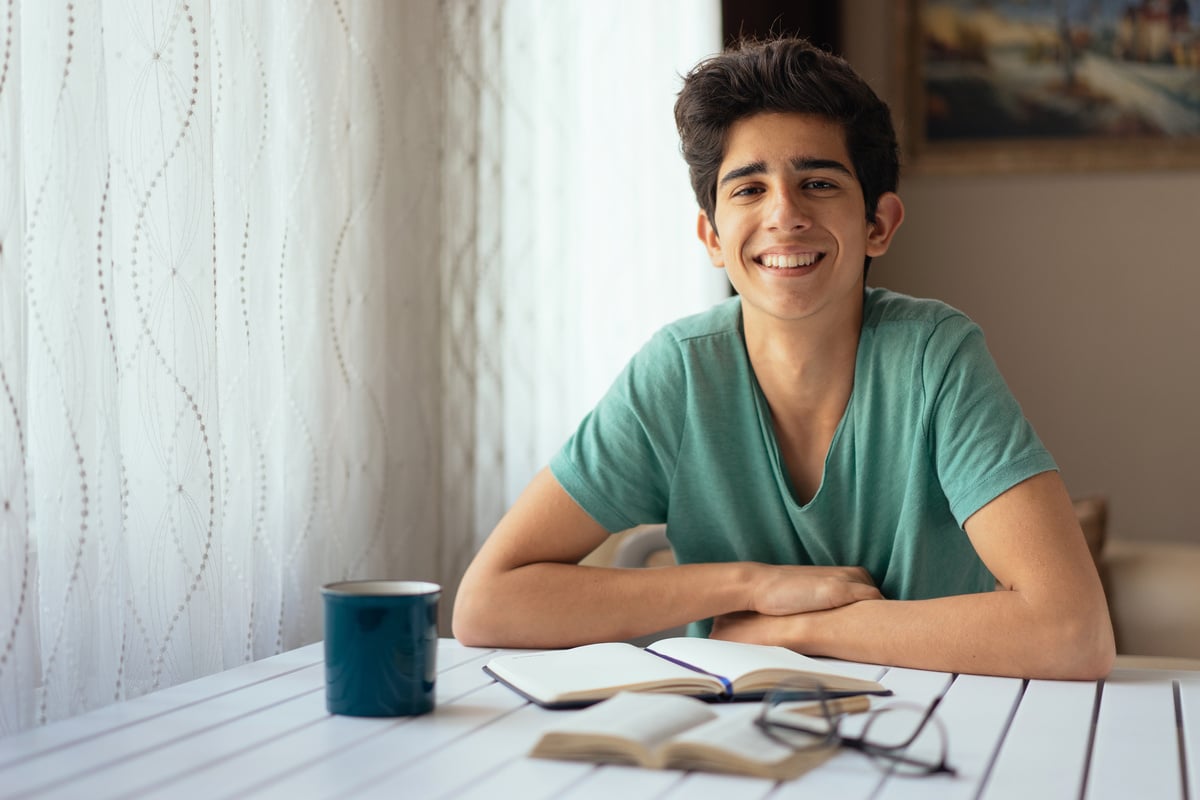 Teenage boy studying at desk